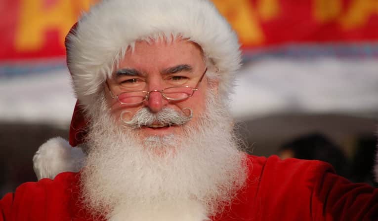 Santa sitting in a chair smiling
